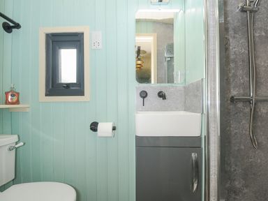 A small bathroom with a toilet sink and shower at Bracken Broad Langdon near Wainhouse Corner