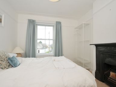 A bedroom with a bed and wardrobe at 2 Glyddins 1910 Rock