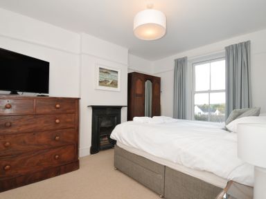 A bedroom with a bed and a television at 2 Glyddins 1910 Rock