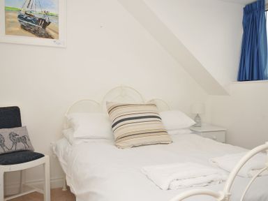 A bedroom with a bed and bedside table at 2 Glyddins 1910 in Rock