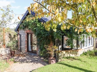 A stone and brick garden room with climbing plants and trees near Tinahely County Wicklow