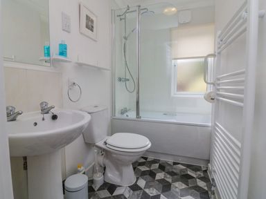 A bathroom with a sink toilet bathtub shower and towel rail at 22 Two Little Ducks in Lynton