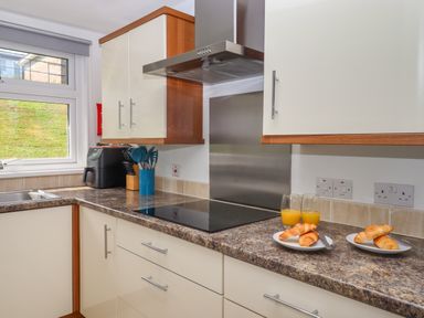 A kitchen countertop with croissants on plates and glasses of orange juice at Florence's Nest in Dartmouth