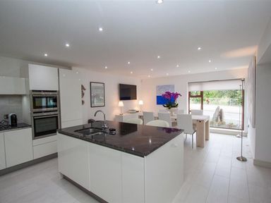 A kitchen and dining area with an island and chairs at The Arthouse in Ambleside