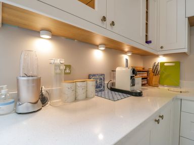 A kitchen countertop with appliances and containers at West View in Feltwell
