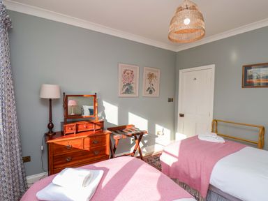 A bedroom with two beds and a nightstand at Roding Cottage in Egton