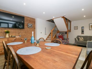 A dining room with a table and chairs at The Hay Barn in Huntley