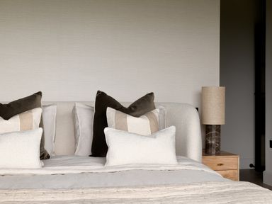 A bed with multiple pillows and a bedside table with a lamp at The Lookout in Longridge