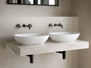 A bathroom with two white oval sinks and wall-mounted faucets at The Lookout in Longridge