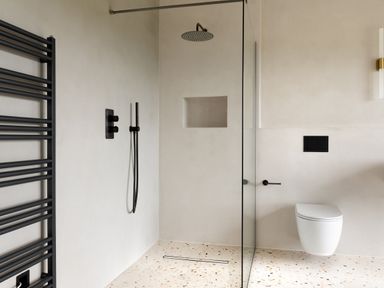 A bathroom with a walk-in shower a wall-mounted toilet a black towel radiator and terrazzo flooring at The Lookout in Longridge