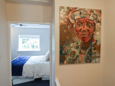 A bedroom with a view of a bed and a painting at 6 Bedford Place in Bridport