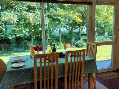 A dining room with a table set for meals at Driftwood in Dartmouth