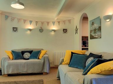 A living room with sofas and wall decorations at Driftwood in Dartmouth