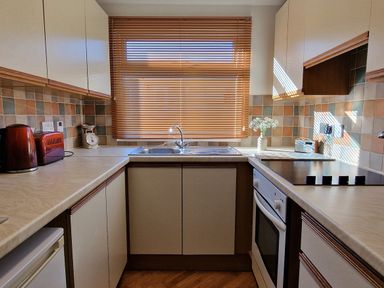 A kitchen with appliances and window light at Driftwood in Dartmouth