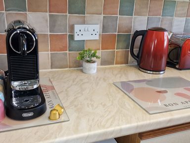 A kitchen with a coffee maker and kettle at Driftwood in Dartmouth