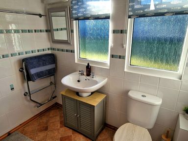 A bathroom with sink and toilet at Driftwood in Dartmouth