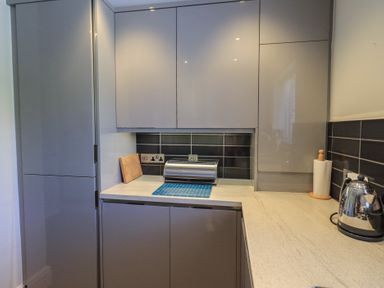A kitchen with cabinets and countertop at Waterfall in Ambleside
