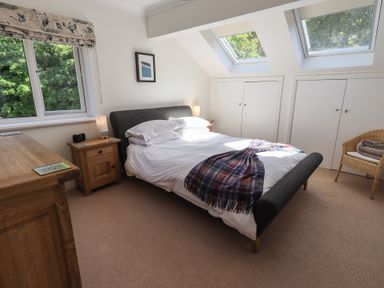 A bedroom with a bed and window at Waterfall in Ambleside