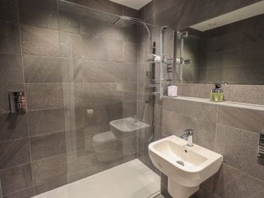 A bathroom with a shower and sink at Waterfall in Ambleside