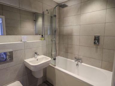 A bathroom with a bathtub and a sink at Waterfall in Ambleside