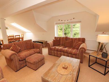 A living room with sofas and a coffee table at Waterfall in Ambleside