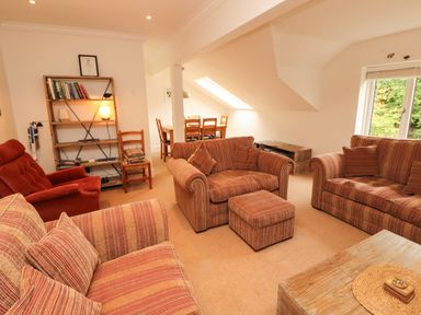 A living room with seating arrangements and a dining area at Waterfall in Ambleside