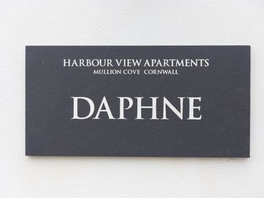 A sign reading Harbour View Apartments Mullion Cove Cornwall Daphne