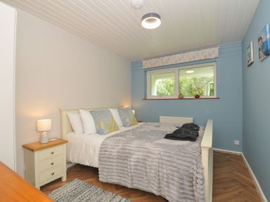 A bedroom with a bed and nightstand at 37 Tamar St Ann's Chapel near Callington