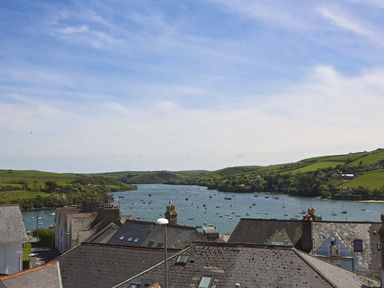 A view of rooftops with a river and boats in the background at Leylands in Salcombe