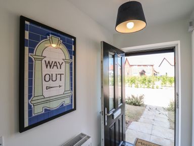 An entrance with a door and a sign at Inishnee House in Shotley Gate