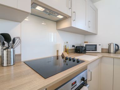 A kitchen with a cooktop, microwave, and kettle at Inishnee House, Shotley Gate