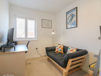 An office with a desk and a sofa at Inishnee House in Shotley Gate