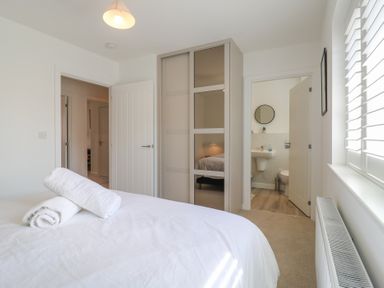 A bedroom with towels on a bed at Inishnee House in Shotley Gate