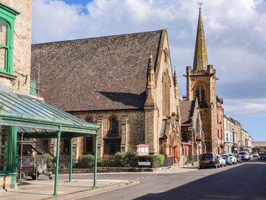 A street view with a church and steeple at Ramson Saltburn-By-The-Sea