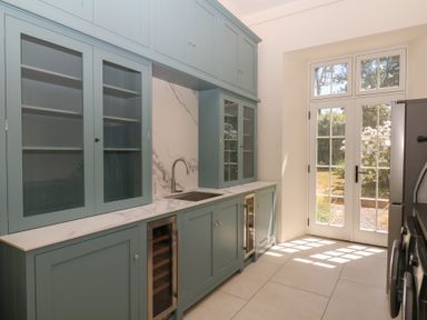 A kitchen with cabinets and a sink at Alston Hall near Mothecombe Beach