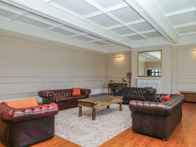 A living room with sofas and a coffee table at Alston Hall near Mothecombe Beach