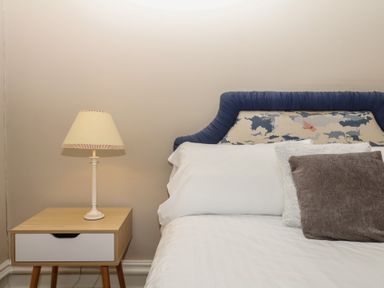 A bedroom with a bed and bedside lamp at Alston Hall near Mothecombe Beach
