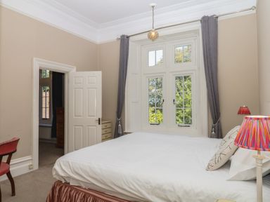 A bedroom with a bed and a lamp at Alston Hall near Mothecombe Beach