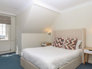 A bedroom with a bed and bedside table at Alston Hall near Mothecombe Beach