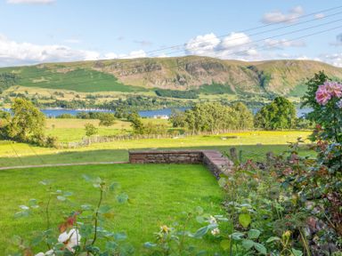 A scenic view of hills and a lake at Bank Barn, Wreay Watermillock