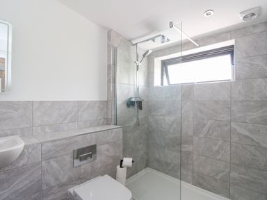 A bathroom with a walk in shower a toilet and a sink at 6 Strathtay Lodges in Aberfeldy