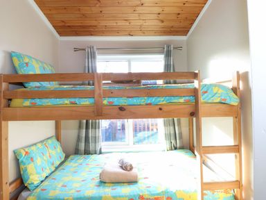 A bedroom with wooden bunk beds and animal print bedding at Brightwater Lodge White Cross Bay near Windermere