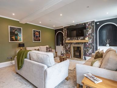 A living room with a sofa and television at Snowdonia Manor in Dolgellau