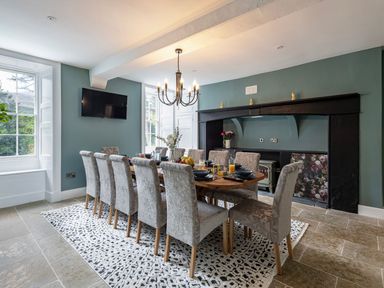 A dining room with a large table and chairs at Snowdonia Manor in Dolgellau