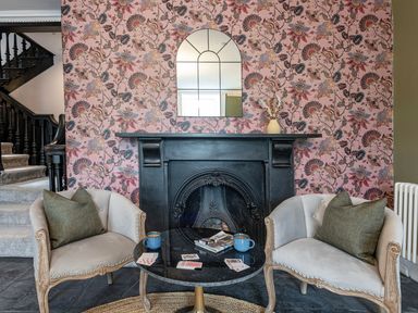 A living room with armchairs and a fireplace at Snowdonia Manor in Dolgellau