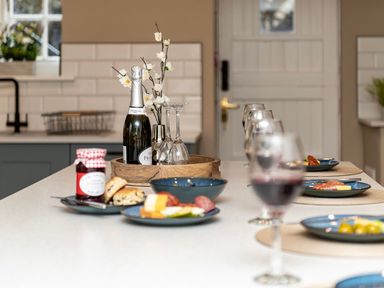 A kitchen with drinks and snacks on the table at Snowdonia Manor in Dolgellau