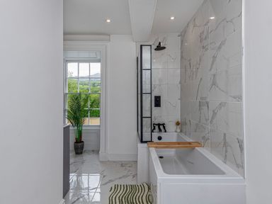 A bathroom featuring a bathtub and window at Snowdonia Manor in Dolgellau