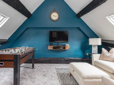 A game room with a foosball table and television at Snowdonia Manor in Dolgellau