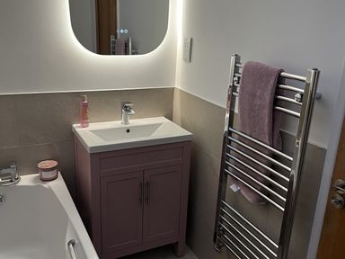 A bathroom with a vanity sink and towel rail at Seascape in Kingsand
