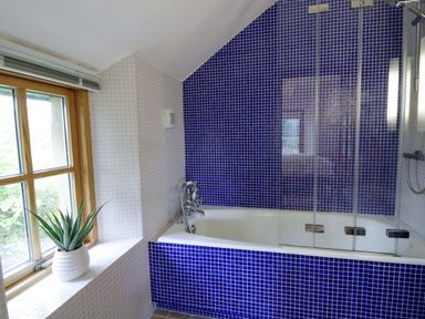 A bathroom with a bathtub and a window at Bryn Isaf in Swyddffynnon near Pontrhydfendigaid